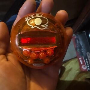 Orange and Red Electronic Toy radica 20 questions electronic game.  Works